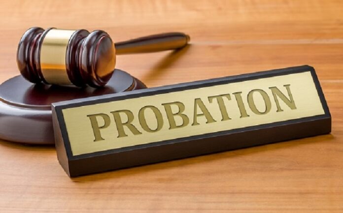 A gavel and a name plate with the engraving Probation Probation